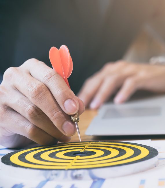 Businessman holding red dart push on target. Business strategy planning success target goals. Business development concept